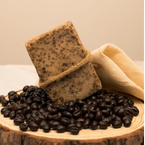Coffee Scrub Handmade Soap with coffee beans on wooden slab